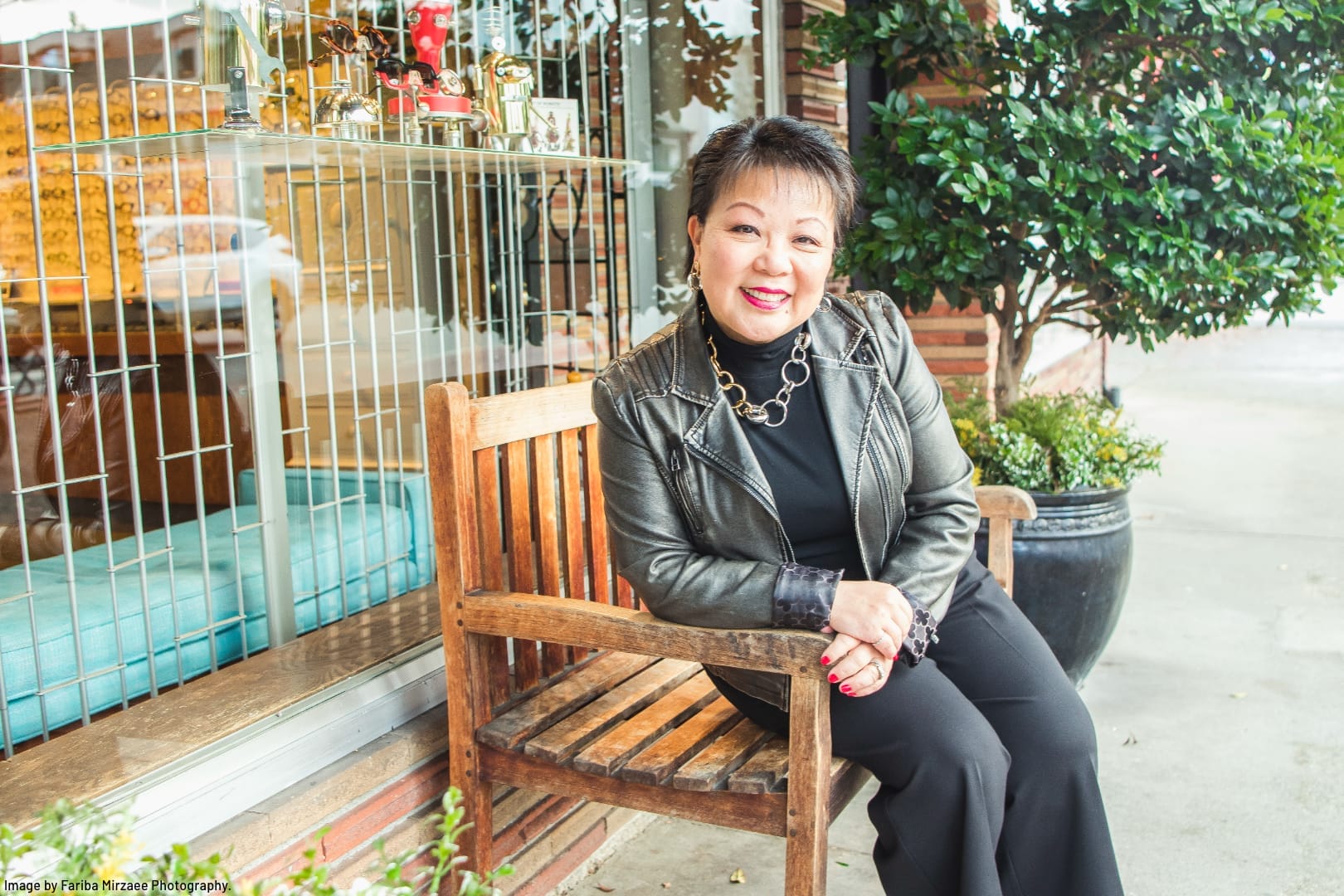 Linda Chu sitting on a bench in the Edgemont Neighbourhood of Vancouver