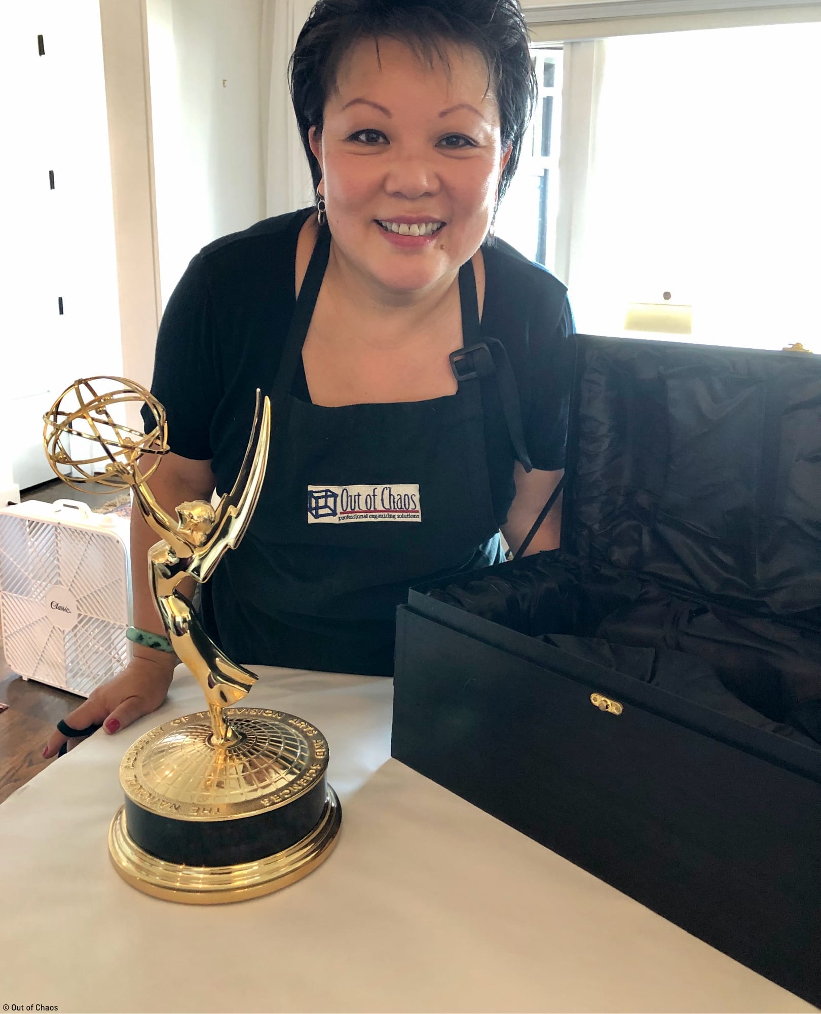 Linda Chu packing a client's Emmy award preparing for a household move