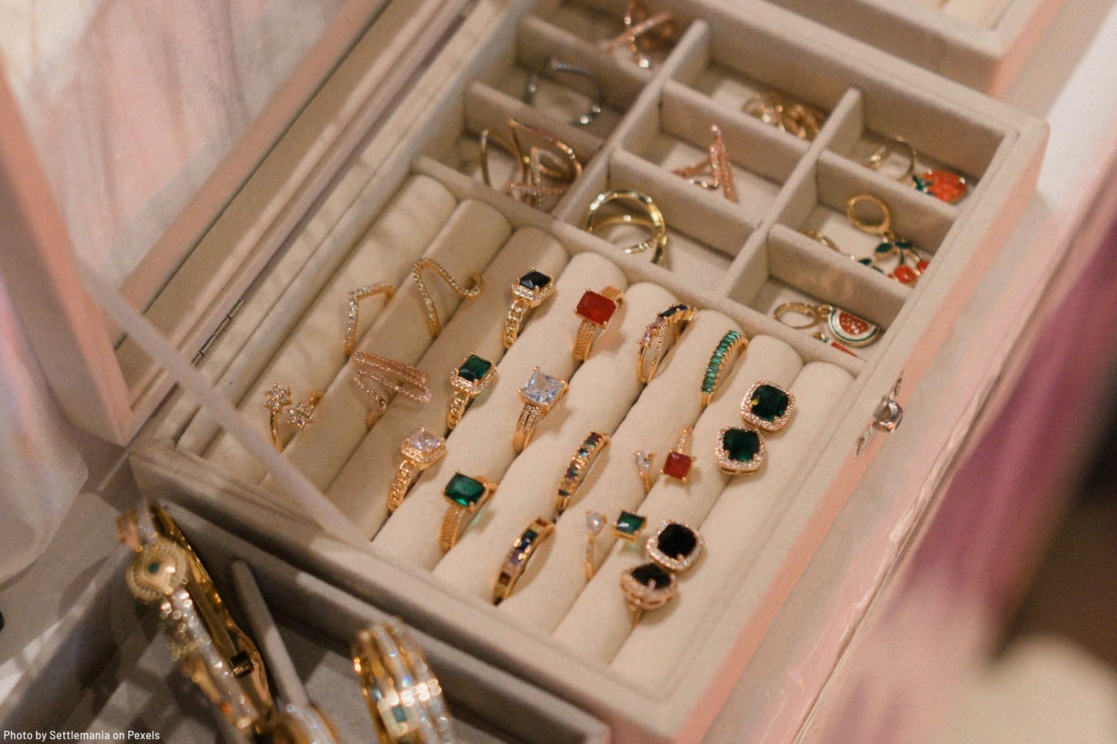 rings and earrings displayed in jewelry box representing the art of jewelry organizing