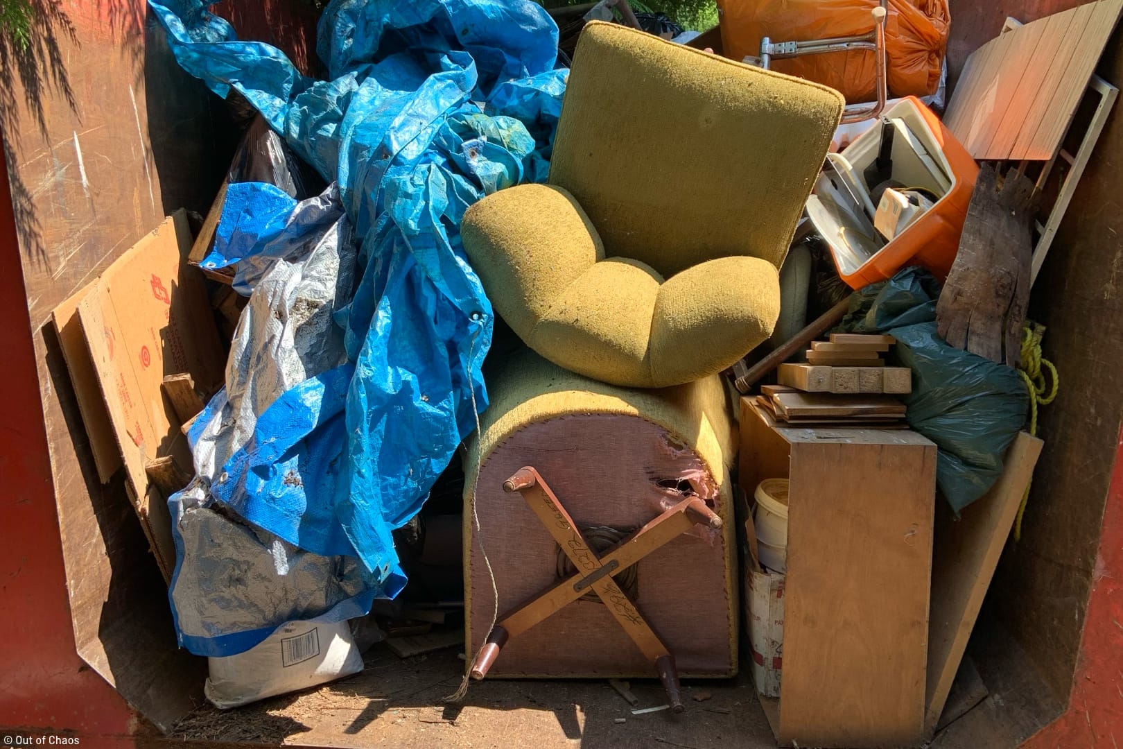 dumpster full of broken, unwanted furniture and household goods