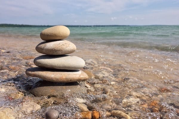 Pile Of Balanced Rocks By Water's Edge