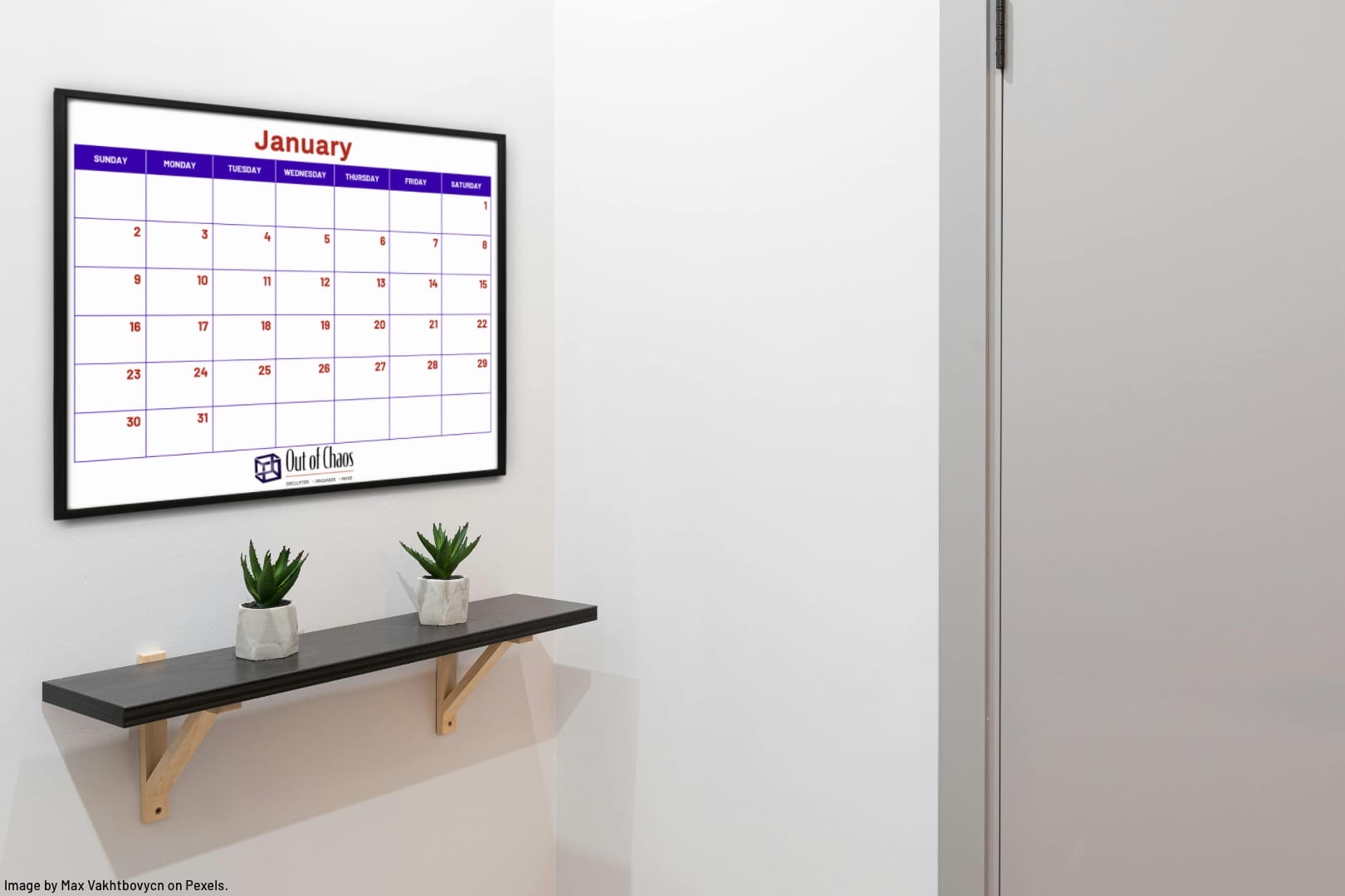 A large family calendar on a wall above shelf showing a one-month view