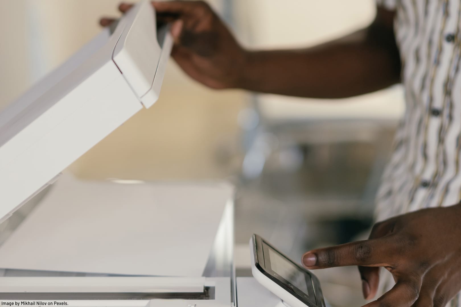 a person of colour scanning paperwork