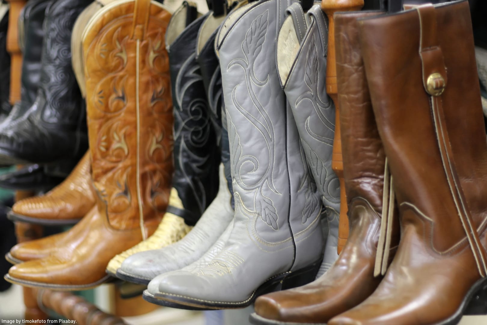 leather cowboy boots lined up on a shelf representing great ways to store boots