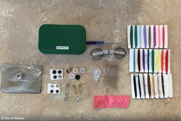 A travel mending kit made with supplies from home and stored in a painted Altoids container