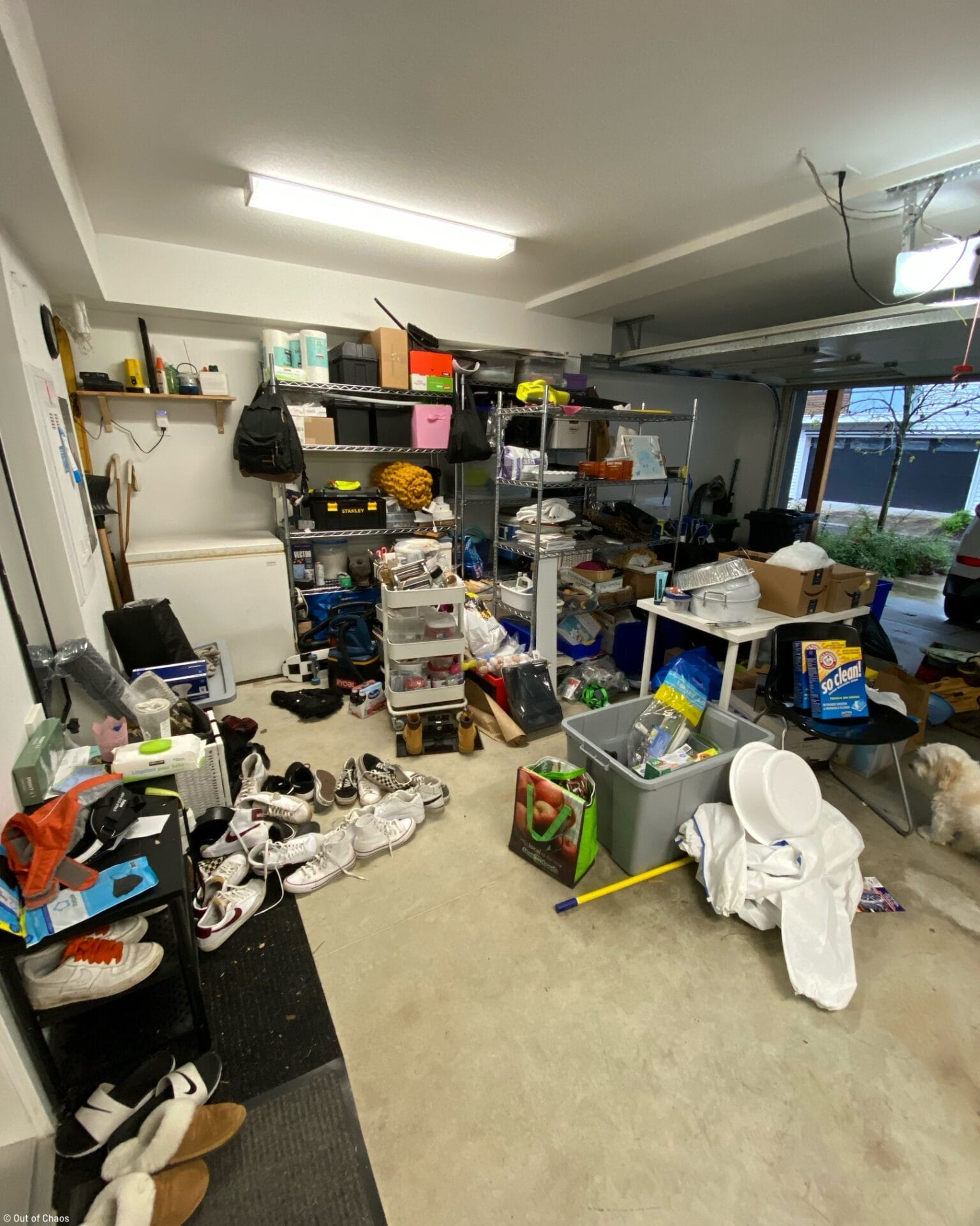 messy garage with shoes and household items all over the floor