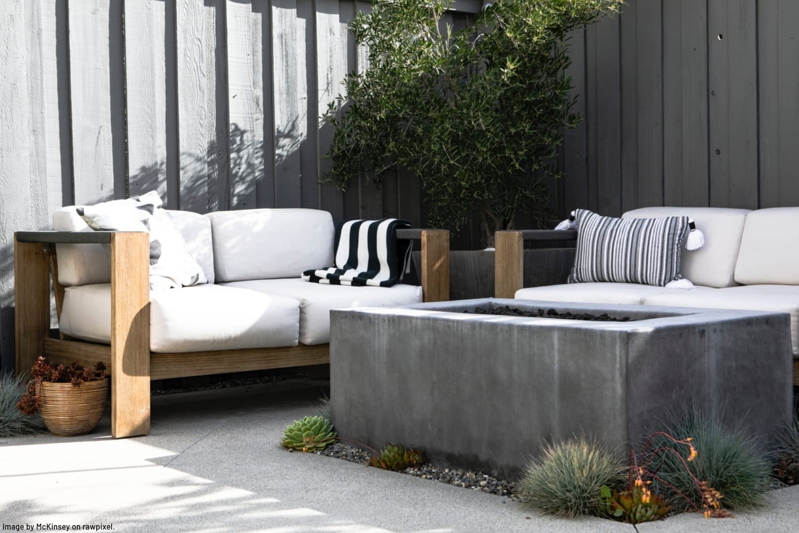 large furniture surrounding a stone fire pit on a patio