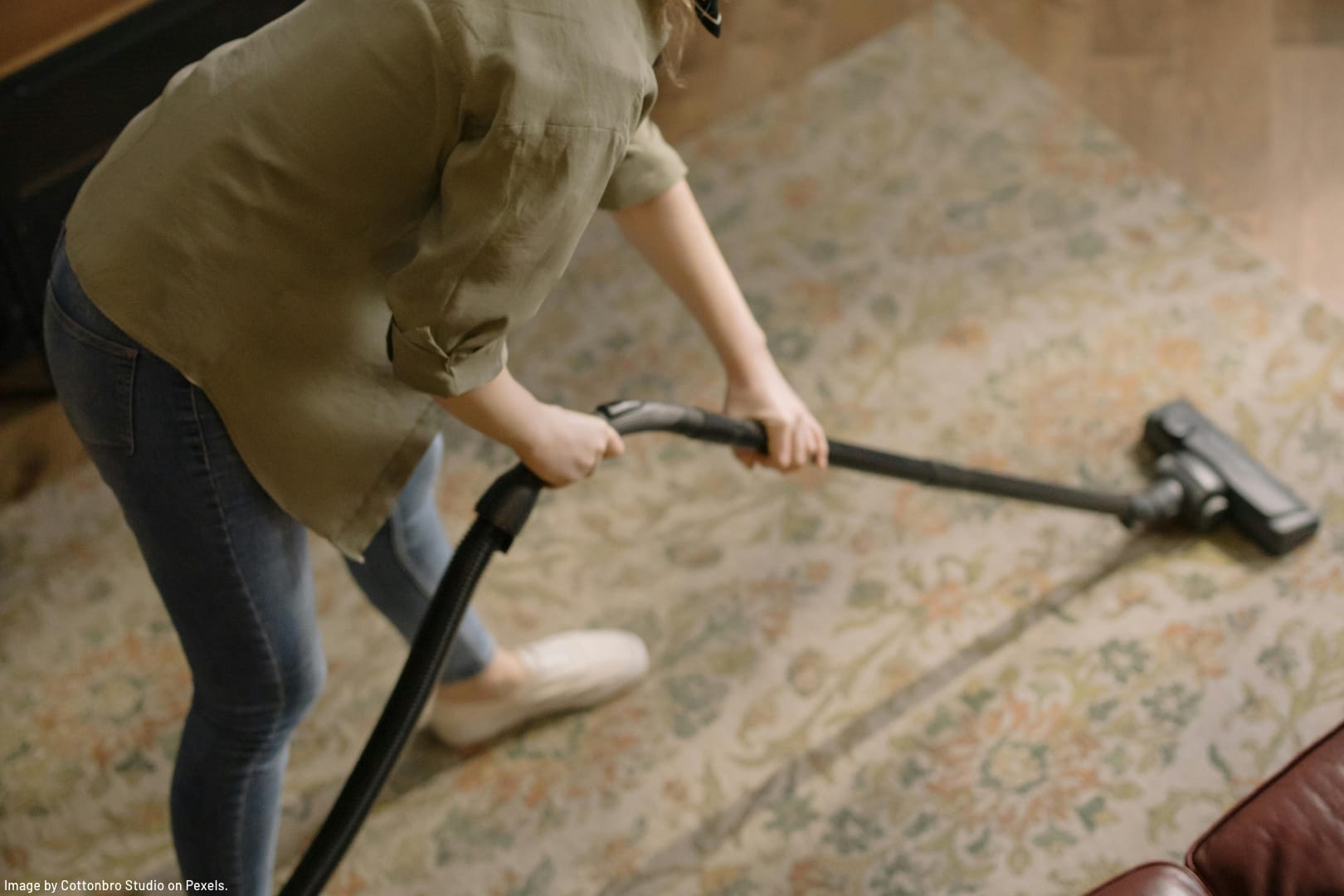 woman vacuuming carpet illustrating spring cleaning myths